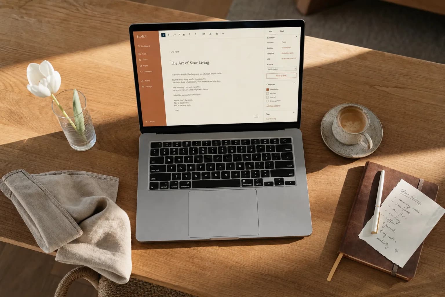 Host creating a welcome page on a laptop over a warm morning desk